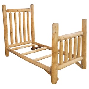 May include: A rustic, unfinished wooden bed frame. The headboard and footboard feature vertical log-style supports, connected by horizontal rails. The natural wood has visible knots and a light brown color, suggesting a cabin or lodge theme.