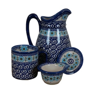 May include: A blue and white ceramic pitcher, mug, and bowl set with a floral and swirl pattern.