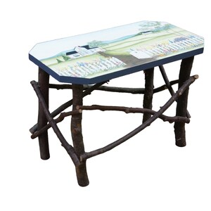 May include: A rectangular side table with a dark blue edge and a flat top surface featuring a painted landscape scene of a white house, green fields, and a white picket fence. The table base is constructed from four dark brown tree branches.