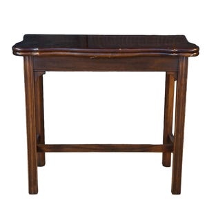 May include: A rectangular wooden table with a dark brown finish, featuring a smooth top with slightly curved edges, four straight legs, and a horizontal support bar connecting the legs near the base, providing a stable and functional furniture piece.