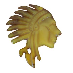 May include: A yellow plastic Native American headdress profile with a feathered headdress.