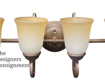 May include: Four-light vanity light fixture with a distressed bronze finish and frosted glass shades. The fixture has a simple, elegant design and would be a great addition to any bathroom.