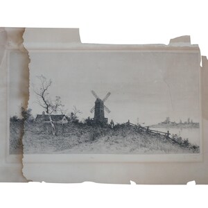 May include: A black and white etching on aged paper with torn edges, depicting a rural landscape with a central windmill, a small cottage, a bare tree, a wooden fence, and a figure standing near the structure under a clear, pale sky.