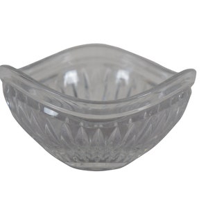 May include: A clear glass bowl with a square shape and a diamond pattern on the sides.