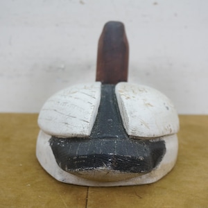 May include: A vintage wooden duck decoy, hand-painted with a white body, black accents, and a brown neck. The decoy has a weathered appearance, suggesting it's an antique or a rustic decorative item.