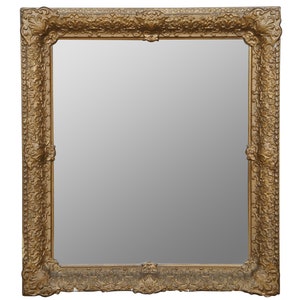 May include: A large, ornate gold-colored picture frame with a beveled mirror inside.