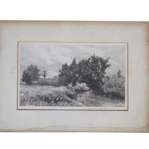 May include: A black and white landscape etching on paper featuring a winding stream flowing through a grassy field with dense trees under a cloudy sky. The artwork is mounted on a rectangular off-white mat with visible aged paper edges.