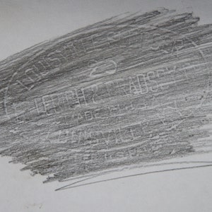 May include: A close-up of a gray, textured, rectangular surface with the word "remarkable" printed in white.