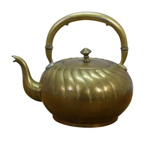 May include: A brass tea kettle featuring a rounded body with a swirling fluted pattern, a curved spout, and a high arched handle. The lid is topped with a small, tiered knob. The metal surface displays a warm, aged golden patina throughout.
