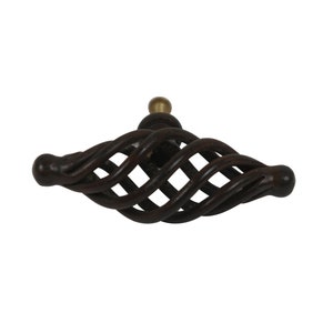 May include: A dark brown metal cabinet knob with a twisted, cage-like design. The knob has a small, round, brass-colored accent on top.