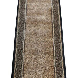 May include: A long runner rug with a black border and a brown and beige leopard print pattern.