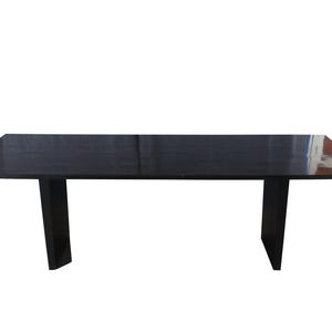 May include: A rectangular, dark-stained wooden table with a glossy finish. The table has a simple design with two sturdy, rectangular legs. The table's dimensions are approximately 72 inches long and 36 inches wide.