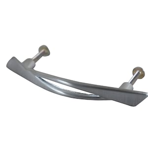 May include: A silver-toned cabinet pull with a curved, modern design. The pull has a smooth, brushed finish and two mounting holes.