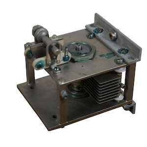 May include: A silver metal capacitor with a silver metal frame and a silver metal knob. The capacitor has a series of metal plates inside the frame.