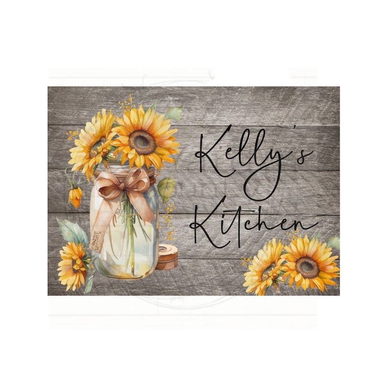 May include: A rustic wooden sign with the text "Kelly's Kitchen" in black script. A mason jar filled with sunflowers and a brown ribbon sits on the left side of the sign.