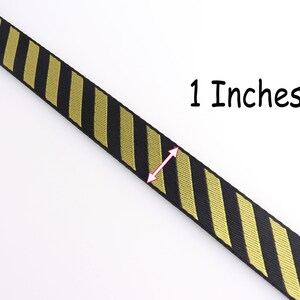 May include: Black and gold striped ribbon with a measurement of 1 inch.