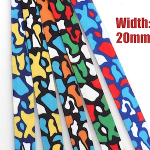 May include: Five colorful patterned lanyards, each with a different color scheme. The lanyards are 20mm wide and feature a black background with white and colored abstract shapes.  Width: 20mm