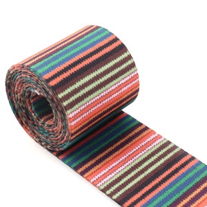 May include: A roll of colorful striped webbing with a variety of colors including red, orange, green, blue, and brown.