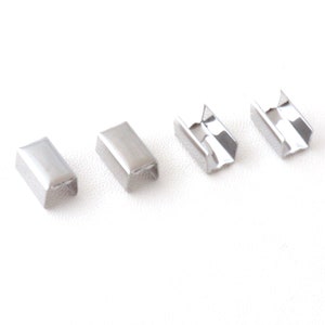 Puede incluir: Cuatro hebillas deslizantes de metal plateado para correas o cinturones. Las hebillas son rectangulares y tienen un acabado liso y brillante.