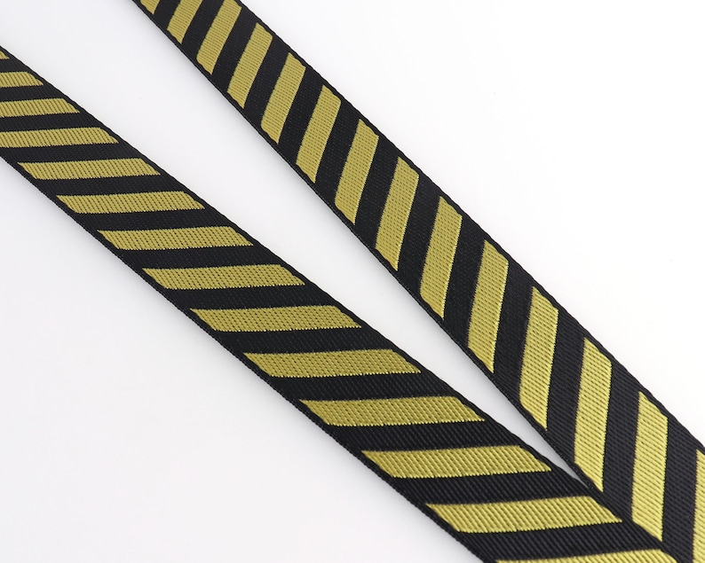 May include: Black and gold striped webbing with a chevron pattern.