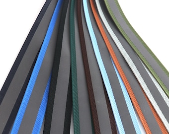 May include: Assortment of 12 different colored ribbon trims with reflective accents. The ribbons are all flat and have a smooth texture. The colors include black, blue, green, gray, brown, and orange.