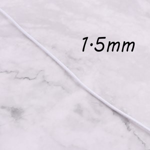 May include: White elastic cord with a 1.5 mm diameter, shown on a white marble surface.
