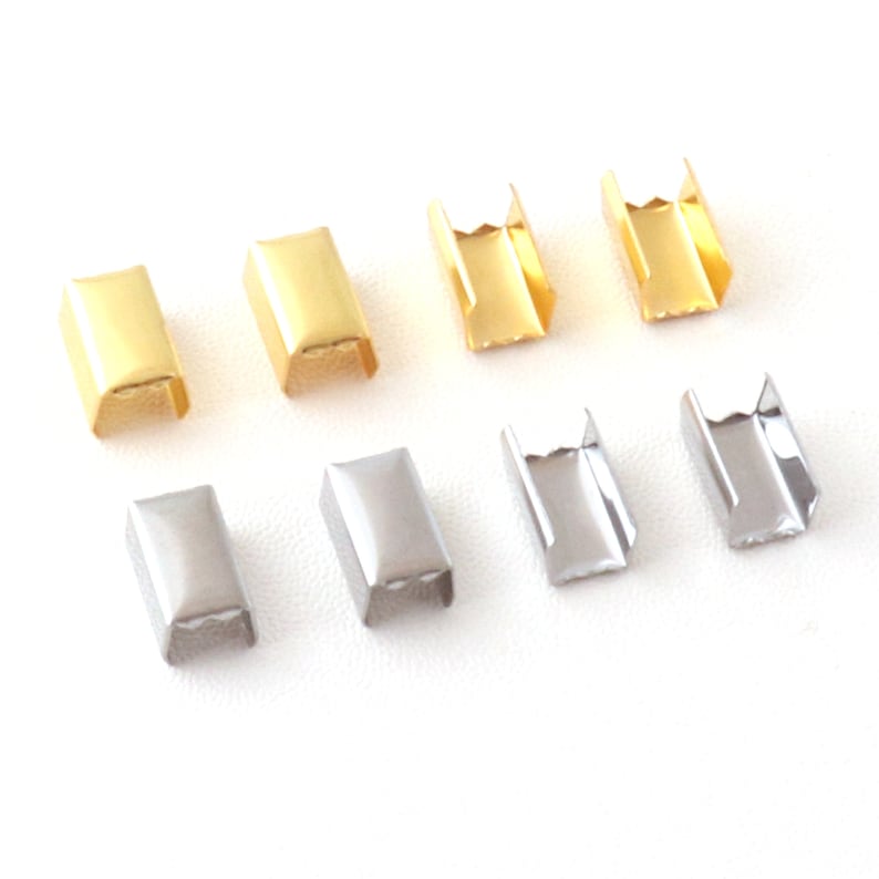 Puede incluir: Un juego de diez terminales de cord&oacute;n de metal en dos acabados: dorado y plateado. Los terminales de cord&oacute;n son rectangulares con una peque&ntilde;a abertura en un lado.