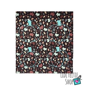 May include: A square fabric with a repeating pattern of four pumpkin outlines in light blue, each filled with a fall leaf design. The background is a dark brown with various leaves in shades of brown, tan, and light green.