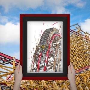 May include: A framed black and white illustration of a roller coaster train going up a wooden track. The train is red and black and the track is brown. The illustration is surrounded by a red frame.