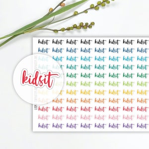 May include: A sheet of colorful stickers with the word "kidsit" repeated in a rainbow pattern. The stickers are perfect for planners, journals, and other craft projects.