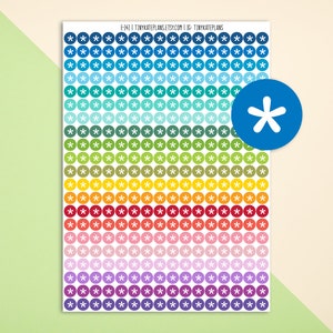 May include: A sheet of colorful round stickers with a white star in the center. The stickers are arranged in rows of 10, with each row featuring a different color. The colors include blue, teal, green, yellow, orange, red, pink, purple, and white.