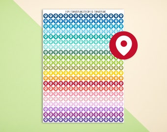 May include: A sheet of colorful location sticker labels with a white pin icon in the center of each circle. The stickers are arranged in rows of 10, with each row featuring a different color. The colors include blue, teal, green, yellow, orange, red, pink, purple, and dark purple.