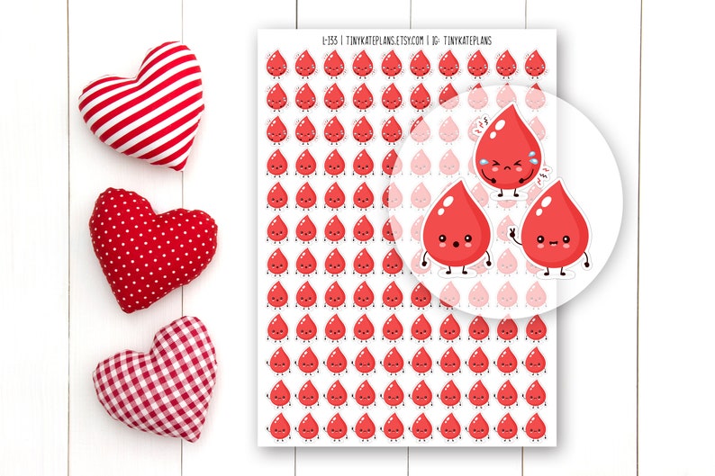 May include: A sheet of red blood drop stickers with different facial expressions. The stickers are arranged in a grid pattern on a white background. The sheet is labeled "I-135 TinyKatePlans Etsy.com IG: TinyKatePlans".