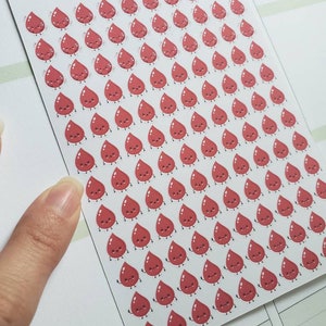 May include: A sheet of red blood drop stickers with cute faces. The stickers are arranged in a grid pattern on a white background. The text "L-135 | TINYKATEPLANS.ETSY.COM | IG: TINYKATEPLANS" is printed at the top of the sheet.