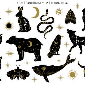 May include: A set of 12 black and gold stickers featuring various celestial and animal illustrations. The stickers include a bear, wolf, owl, rabbit, cat, whale, butterfly, moth, snake, and skull. The stickers are perfect for adding a touch of whimsy and magic to your journals, laptops, water bottles, and more.