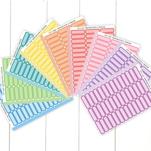 May include: A set of ten sheets of colorful rectangular labels with rounded corners. Each sheet has a different color, including blue, green, yellow, orange, red, pink, and purple. The labels are bordered with a thin black line and have a white background.