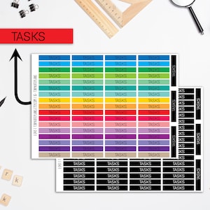 May include: A set of colorful and black task stickers with the word "TASKS" printed on each sticker. The stickers are arranged in rows and columns on a white background.