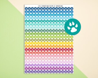 May include: A sheet of colorful paw print stickers with a white paw print on each sticker. The stickers are arranged in rows of 10, with each row a different color. The colors are blue, teal, green, yellow, orange, red, pink, purple, and brown. The sheet is labeled "E-256 | TINYKATEPLANS.ETSY.COM | #TINYKATEPLANS".
