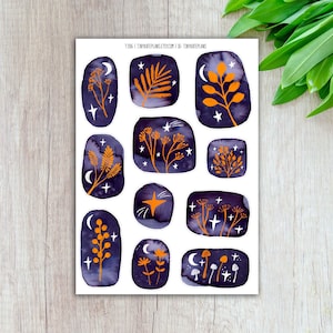 May include: A sticker sheet featuring eleven individual die-cut stickers with dark purple watercolor backgrounds. Each sticker displays orange botanical illustrations, white crescent moons, and white stars. The text T-206 | TINYKATEPLANS.ETSY.COM | IG: TINYKATEPLANS is printed at the top.