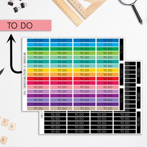 May include: A set of colorful "To Do" list stickers with a rainbow color scheme. The stickers are arranged in rows and columns, with each sticker having the words "To Do" printed on it. There are also black and white "To Do" stickers.