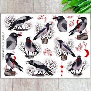 May include: A sticker sheet featuring various illustrations of crows with black and gray feathers, perched on branches or rocks. Red accents include leaves, a crescent moon, and stars. The text "TINY KATE PLANS. ETSY.COM" is visible.