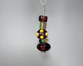 Purple, Green, and Yellow Artisan Furnace Glass and Lampwork Pendant wrapped in Sterling Silver