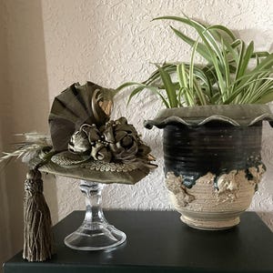 May include: A set of three ceramic mugs with a speckled, matte finish. Each mug features a different color: light blue, cream, and gray. The mugs have a simple, modern design and a comfortable handle.