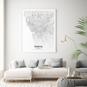 May include: A black and white line art map print of Porto, Portugal. The map shows the city streets and waterways. The text "PORTO" and "PORTUGAL" are printed below the map, along with the coordinates 41&deg; 09' 43.17" N 8&deg; 37' 38.05" W.