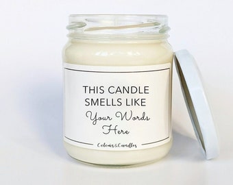 May include: A white candle in a glass jar with a white lid. The label on the jar reads "This candle smells like Your Words Here - Colors & Candles".