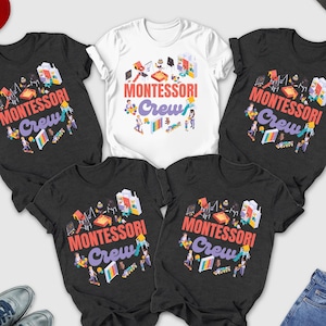 May include: A collection of dark grey heather and white t-shirts with the text "MONTESSORI Crew" in a colorful design. The image also includes a red baseball cap, blue jeans, sunglasses, and sneakers.