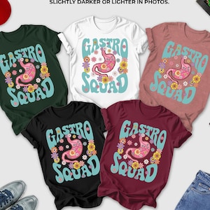 a collection of clothing items, including T-shirts, jeans, and a hat, arranged on a white background.