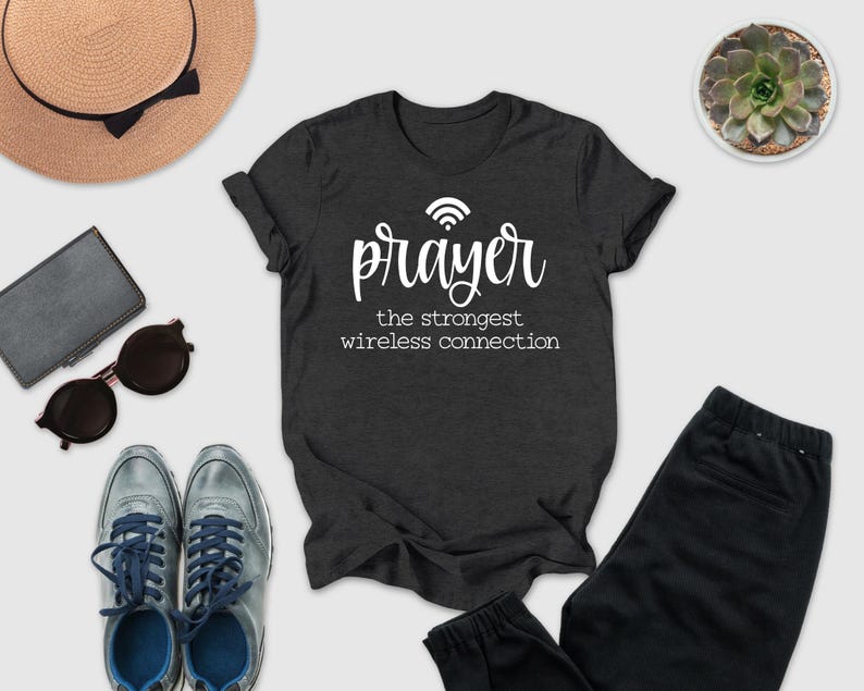 a casual outfit consisting of a black t-shirt with a white text design, a pair of sunglasses, a hat, a wallet, a potted succulent, and a pair of sneakers.