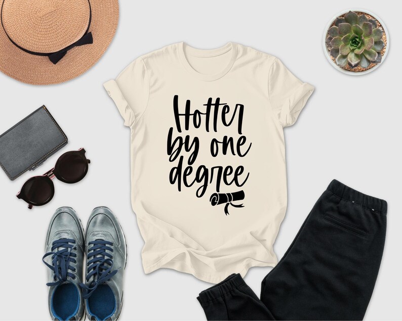 a casual outfit consisting of a white t-shirt with a black text design, a pair of black pants, a pair of sunglasses, a hat, and a small potted plant.