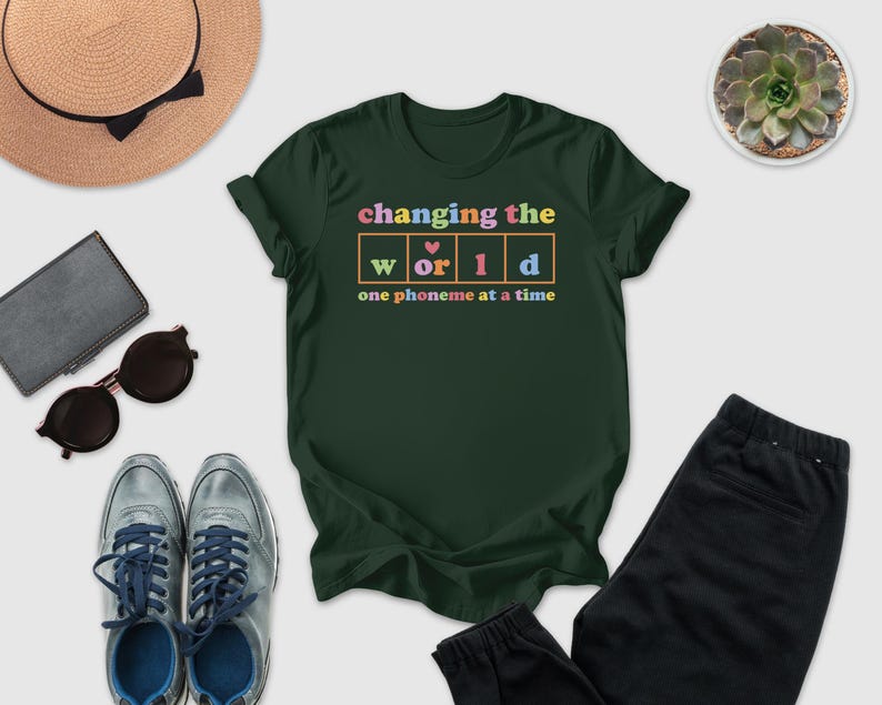 a green t-shirt with a colorful graphic design, along with various clothing items and accessories such as sunglasses, a hat, and a potted plant.